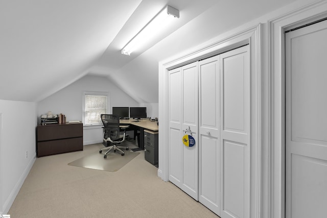 home office with baseboards, lofted ceiling, and light carpet