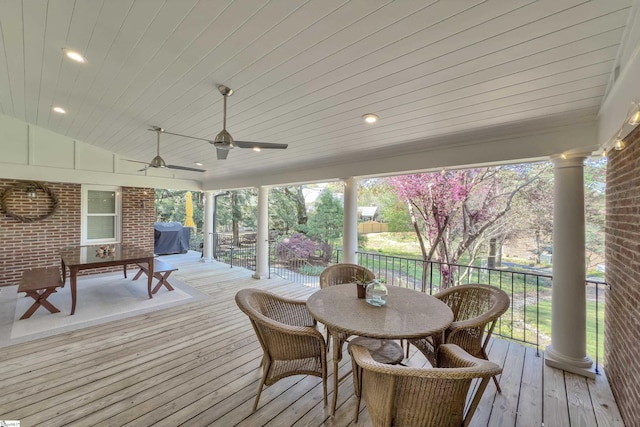 wooden terrace featuring outdoor dining area and a ceiling fan