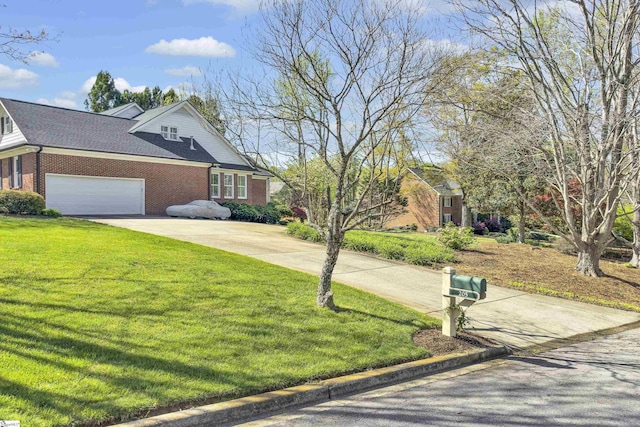 view of front of property featuring an attached garage, brick siding, a front lawn, and concrete driveway