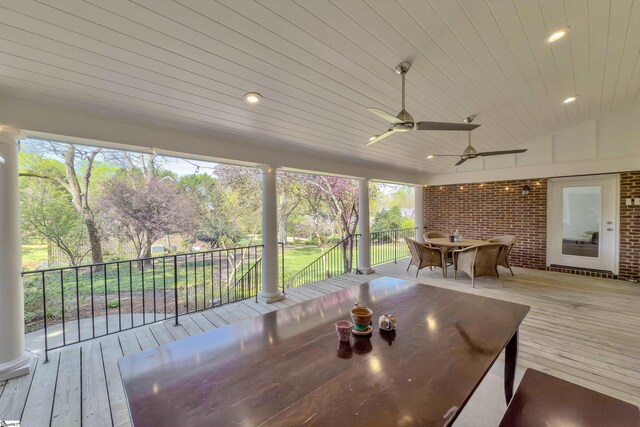 wooden deck featuring outdoor dining area and ceiling fan