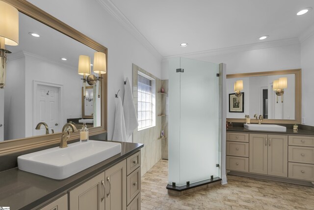 bathroom with recessed lighting, ornamental molding, a sink, and walk in shower