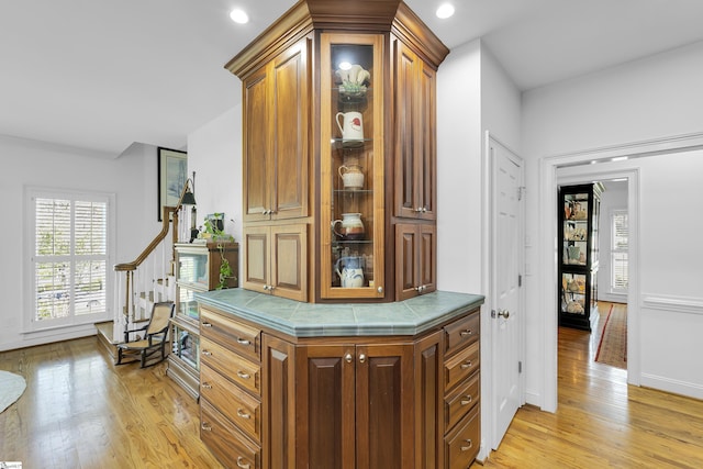hall featuring plenty of natural light, baseboards, light wood-style floors, and recessed lighting
