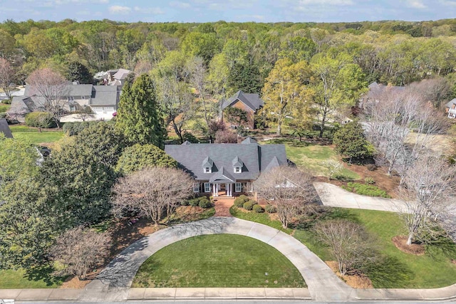 birds eye view of property with a view of trees