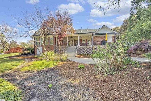 single story home featuring brick siding and a porch