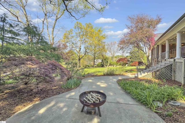 exterior space featuring a fire pit, a patio, and stairway