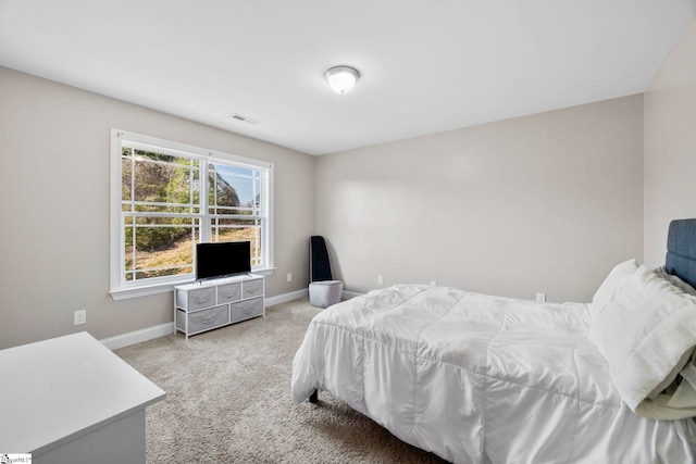 bedroom featuring baseboards, carpet floors, and visible vents