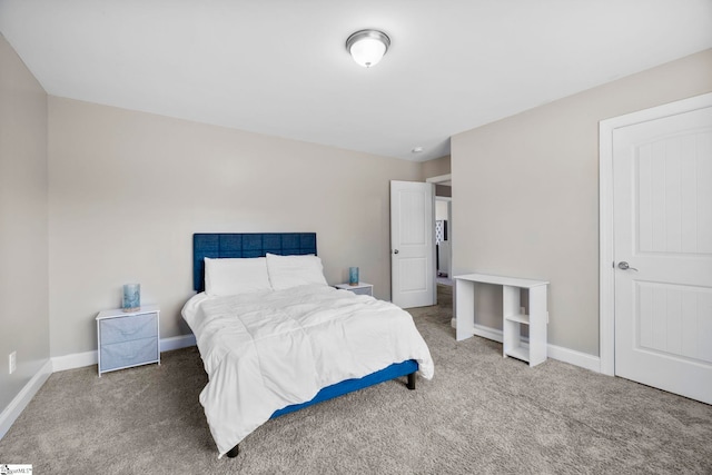 bedroom with carpet flooring and baseboards
