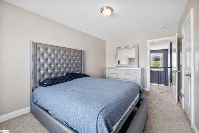 carpeted bedroom featuring baseboards
