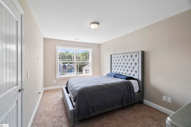bedroom with carpet flooring, baseboards, and visible vents