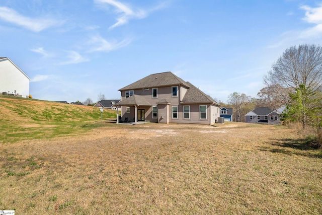 back of house with a yard
