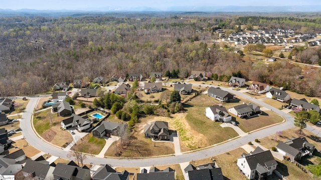 birds eye view of property featuring a residential view and a wooded view