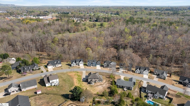 drone / aerial view with a residential view and a forest view