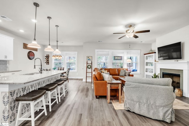 120 Marshfield Trl, Simpsonville, SC 29680 - living room featuring a ceiling fan, light wood-style flooring, a fireplace, recessed lighting, and baseboards