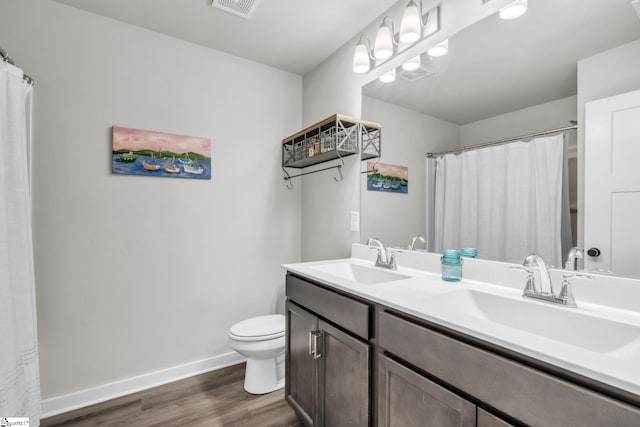 120 Marshfield Trl, Simpsonville, SC 29680 - bathroom with double vanity, toilet, wood finished floors, baseboards, and a shower with shower curtain