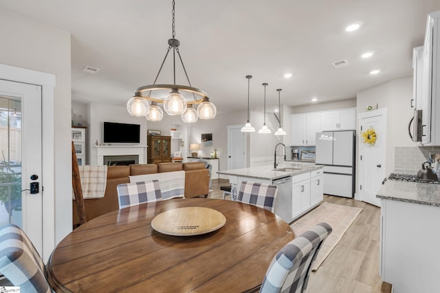 120 Marshfield Trl, Simpsonville, SC 29680 - dining space featuring light wood-type flooring, a fireplace, and recessed lighting