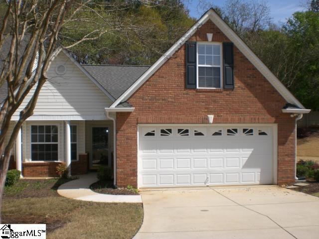 traditional-style home featuring brick siding, concrete driveway, and a garage
