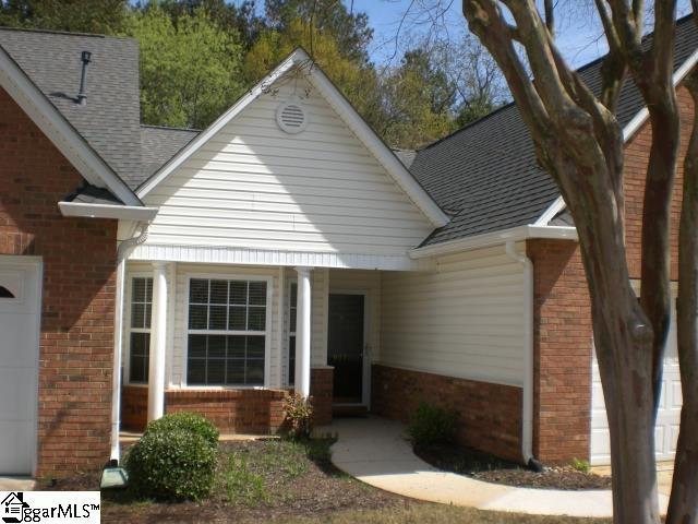 view of front of home with a porch, brick siding, and roof with shingles