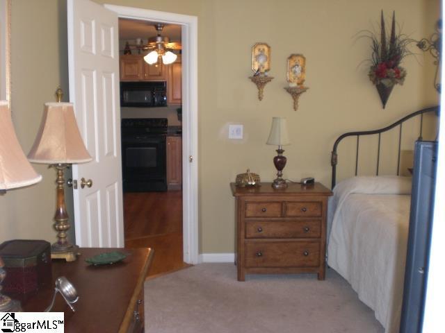 bedroom featuring light carpet