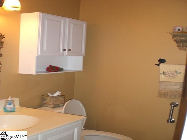 bathroom featuring toilet and vanity