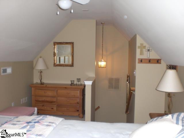 bedroom featuring visible vents and vaulted ceiling