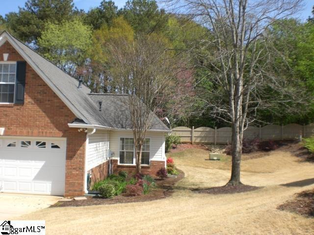 exterior space with roof with shingles, central air condition unit, fence, brick siding, and a garage