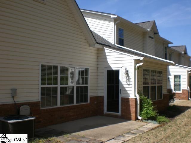 back of house with brick siding, central AC, and a patio area