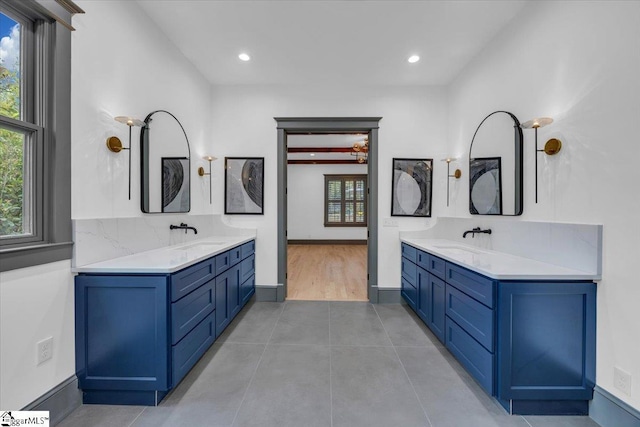 bathroom featuring a sink, tile patterned flooring, and two vanities