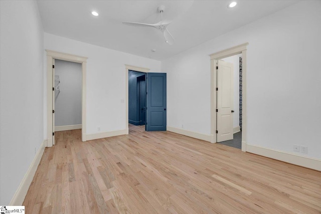 unfurnished bedroom featuring a spacious closet, recessed lighting, baseboards, and light wood-type flooring