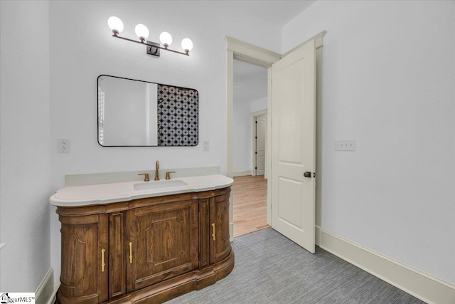 bathroom with baseboards and vanity