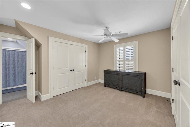 bedroom featuring a closet, a ceiling fan, baseboards, light colored carpet, and visible vents