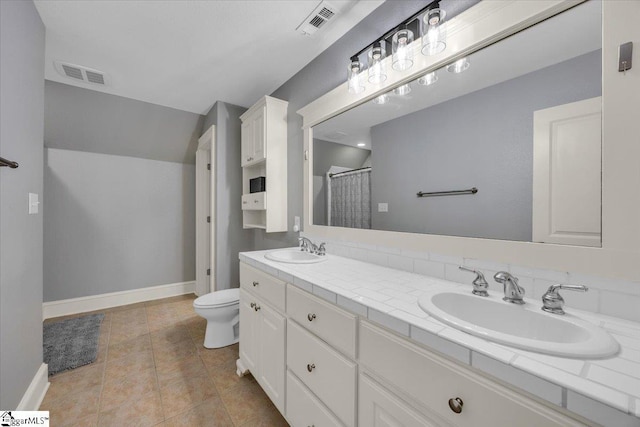 full bathroom with baseboards, visible vents, toilet, and a sink