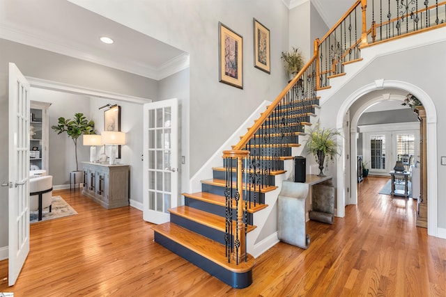 100 Breeds Hill Way, Greer, SC 29650 - staircase featuring arched walkways, wood finished floors, french doors, and crown molding