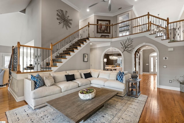 100 Breeds Hill Way, Greer, SC 29650 - living room featuring arched walkways, stairway, and wood finished floors