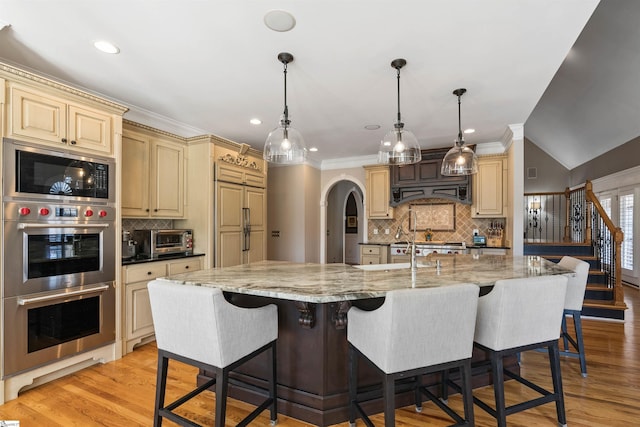 100 Breeds Hill Way, Greer, SC 29650 - kitchen with cream cabinets, stainless steel appliances, and light wood finished floors