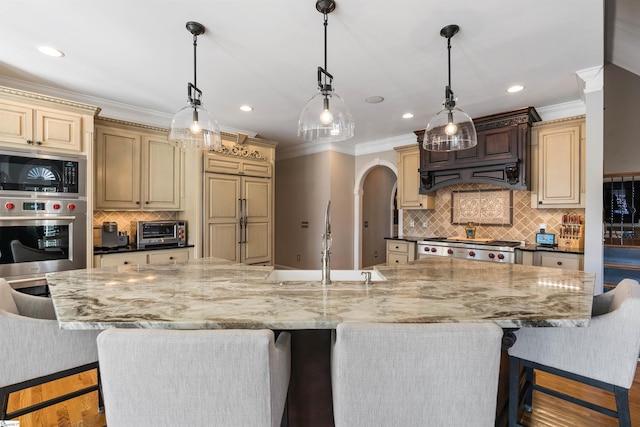 100 Breeds Hill Way, Greer, SC 29650 - kitchen with a toaster, ornamental molding, a sink, built in appliances, and a kitchen breakfast bar