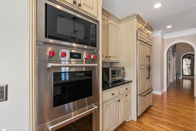 100 Breeds Hill Way, Greer, SC 29650 - kitchen featuring arched walkways, cream cabinets, built in appliances, and crown molding