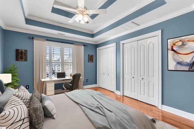 100 Breeds Hill Way, Greer, SC 29650 - bedroom featuring a tray ceiling, visible vents, wood finished floors, and multiple closets