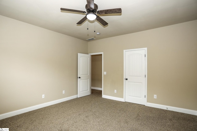 unfurnished bedroom with carpet flooring, a ceiling fan, baseboards, and visible vents