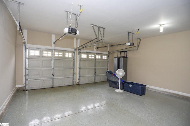 garage with baseboards, water heater, and a garage door opener