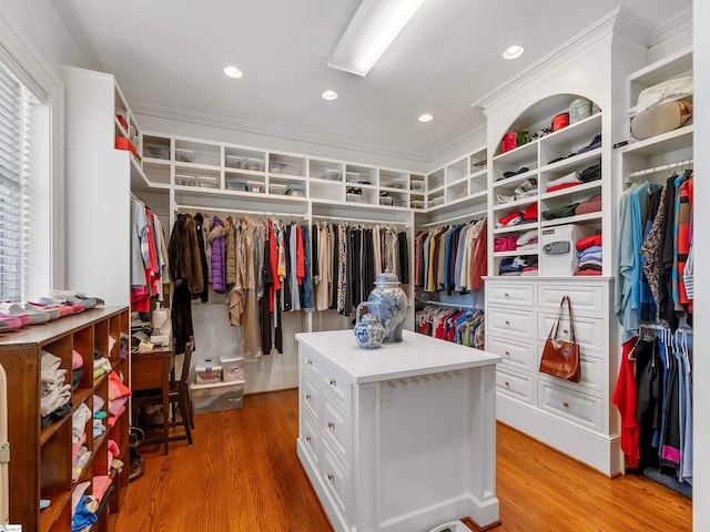 walk in closet with light wood-style flooring