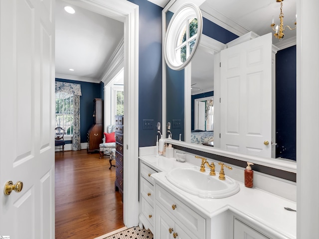 bathroom featuring ensuite bath, crown molding, wood finished floors, and vanity