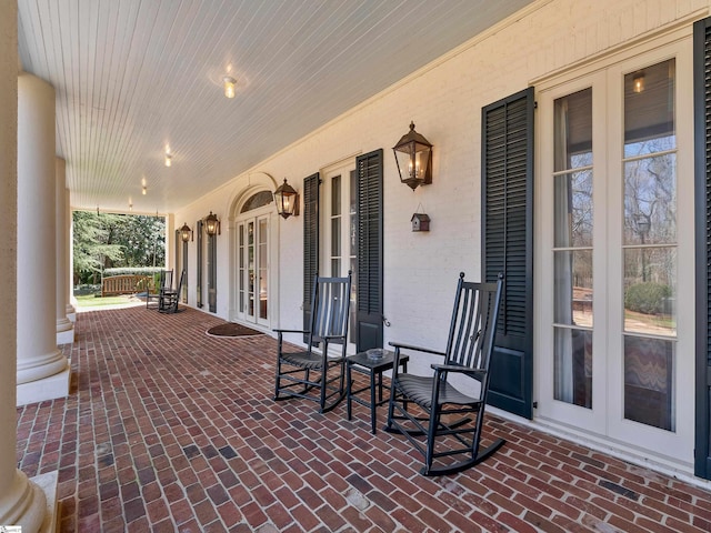 view of patio / terrace with french doors and a porch