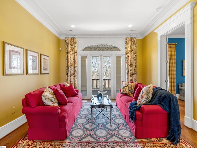 living area with crown molding, recessed lighting, baseboards, visible vents, and wood finished floors