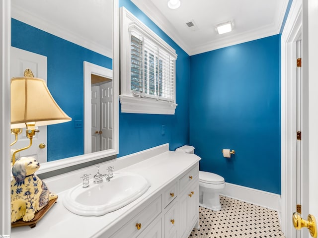 bathroom featuring crown molding, toilet, vanity, tile patterned flooring, and baseboards