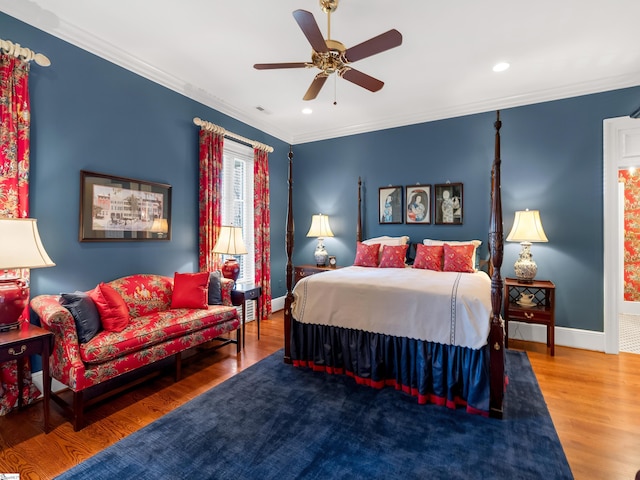 bedroom featuring visible vents, crown molding, baseboards, wood finished floors, and recessed lighting