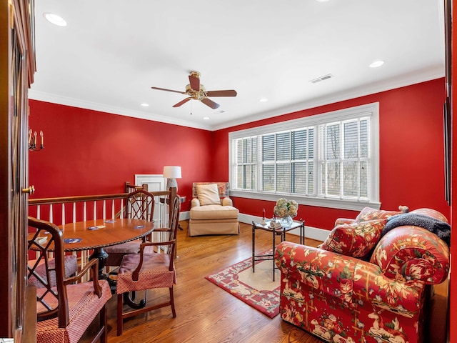 interior space featuring crown molding, recessed lighting, baseboards, visible vents, and wood finished floors