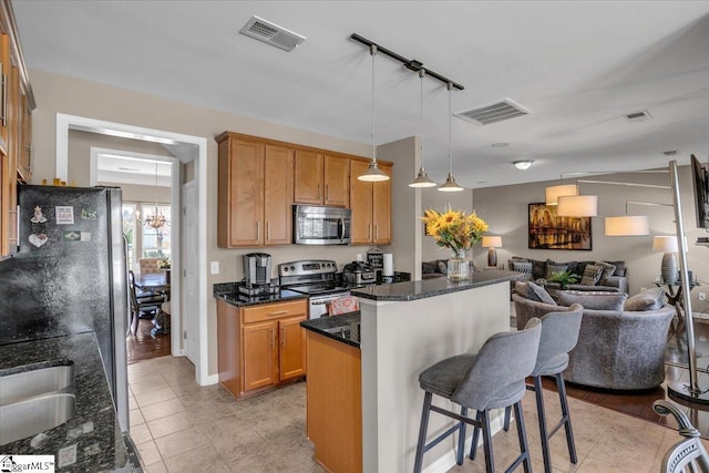 513 Rio Grande Pl, Simpsonville, SC 29680 - kitchen with visible vents, open floor plan, a kitchen breakfast bar, and stainless steel appliances