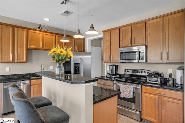 513 Rio Grande Pl, Simpsonville, SC 29680 - kitchen with a breakfast bar, dark stone countertops, a kitchen island, visible vents, and appliances with stainless steel finishes