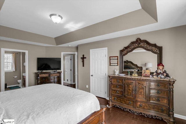 513 Rio Grande Pl, Simpsonville, SC 29680 - bedroom with dark wood-style flooring, a tray ceiling, baseboards, and connected bathroom