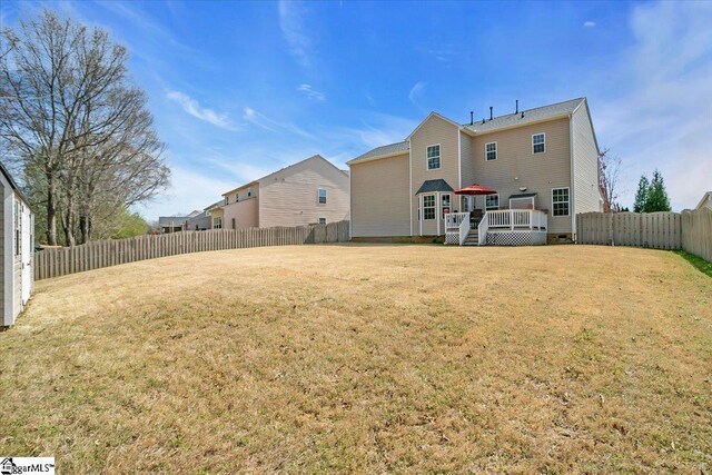 513 Rio Grande Pl, Simpsonville, SC 29680 - back of house featuring a fenced backyard, a wooden deck, and a lawn